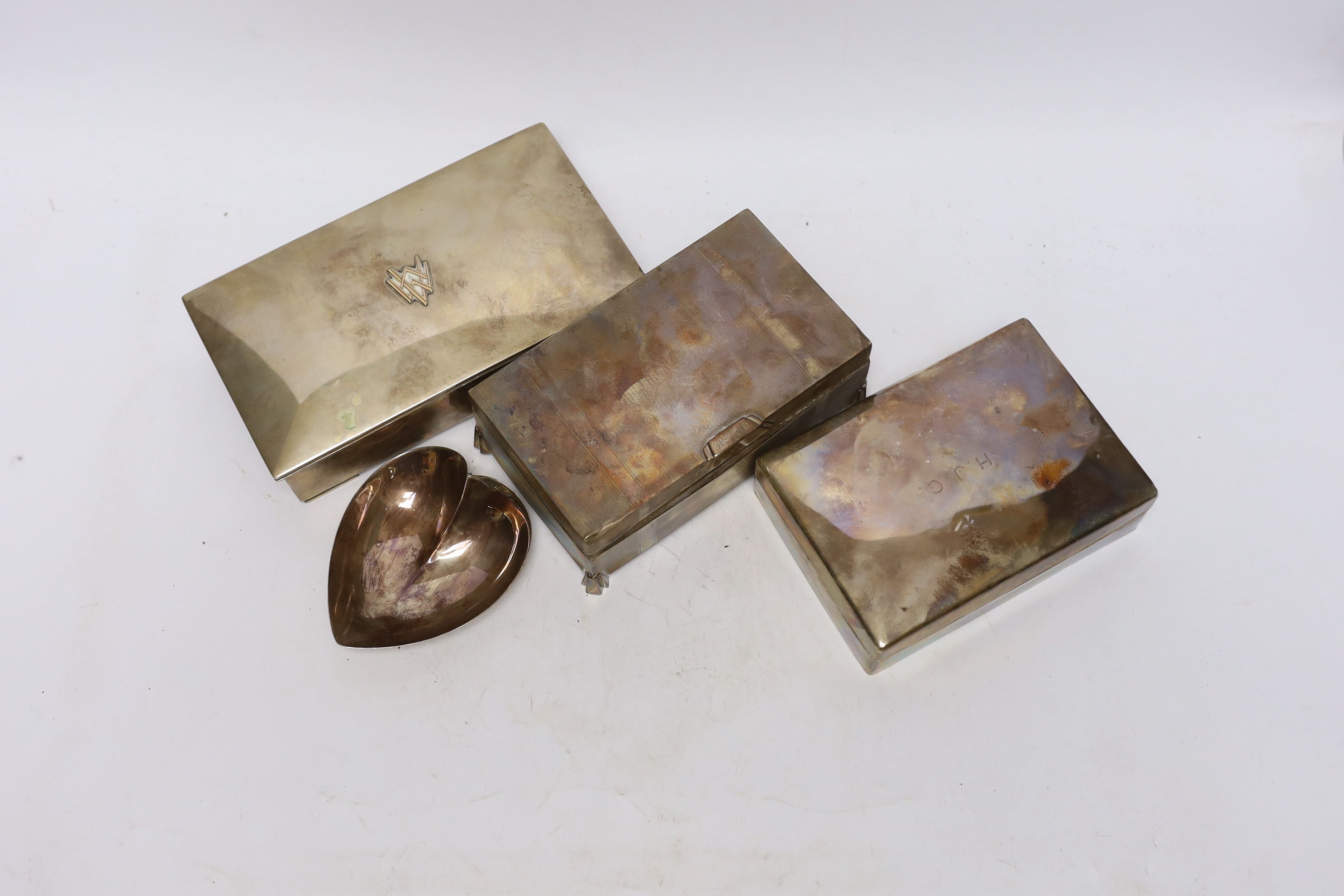 Two silver mounted cigarette boxes, including Art Deco, 15.2cm, together with a Finnish white metal mounted cigarette box and heart shaped dish.